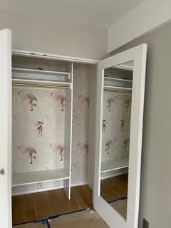 Finished custom closet with multi-level hanging space and accessories