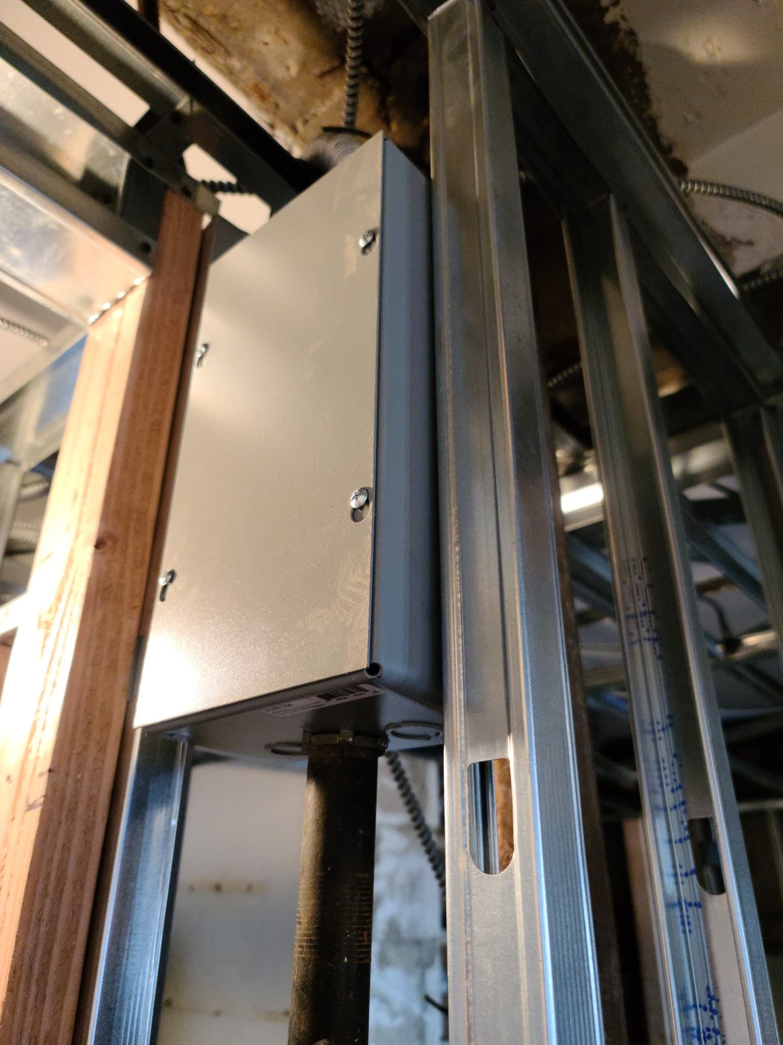 Metal stud framing with electrical junction box installation during gut renovation