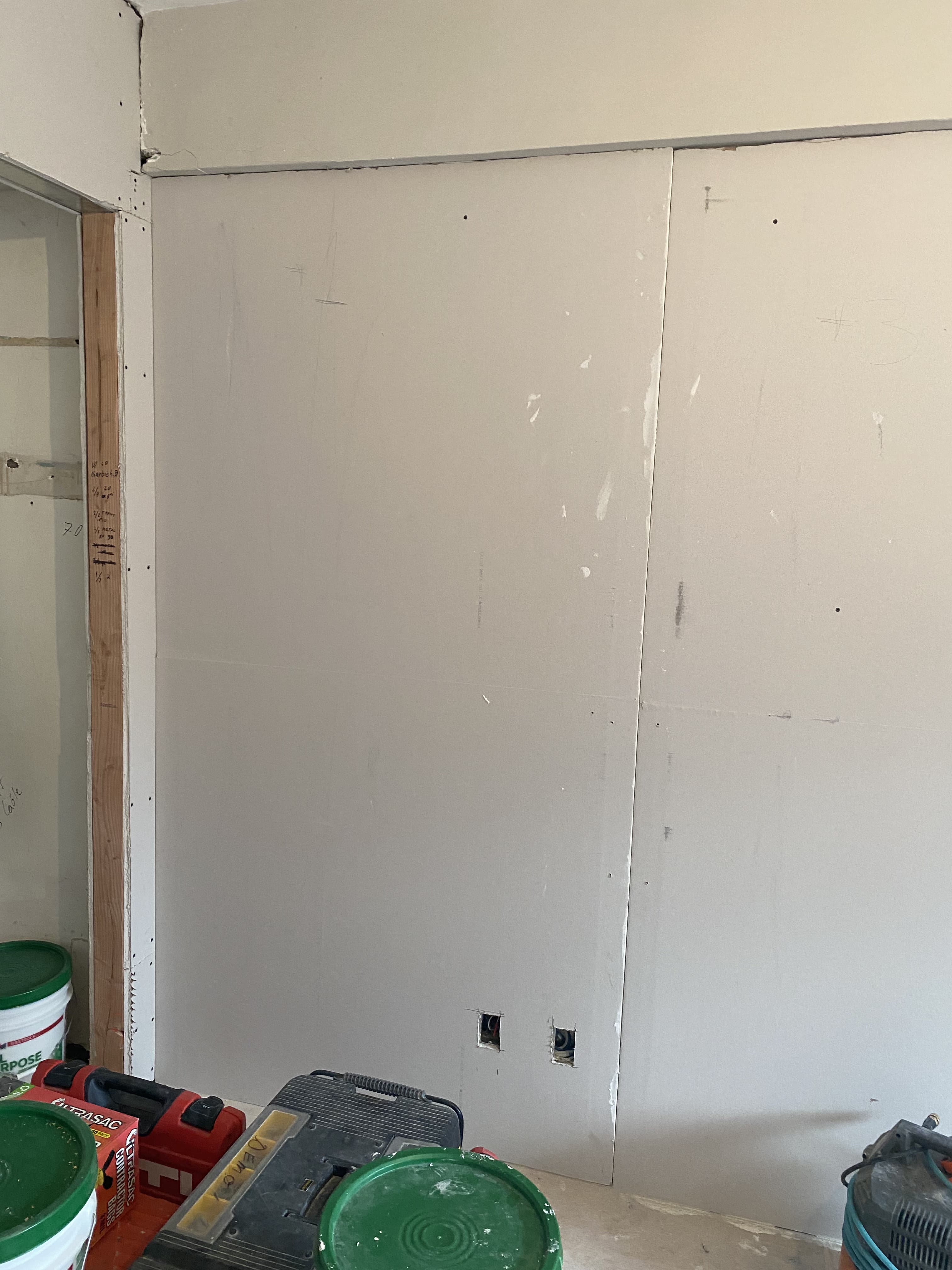 Living space renovation showing fresh wall finishing and trim detail