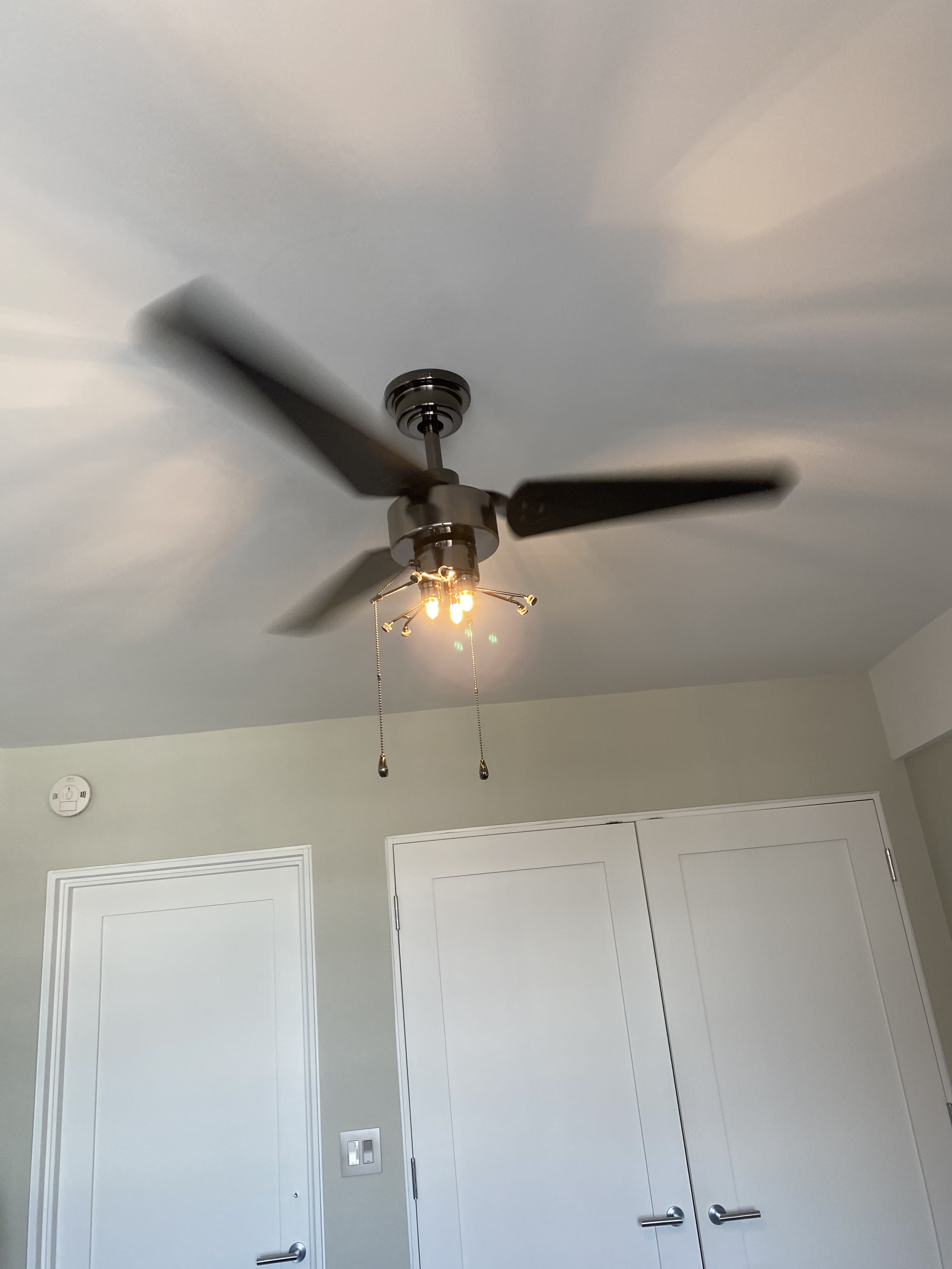 Renovated living space with modern ceiling fan and artwork