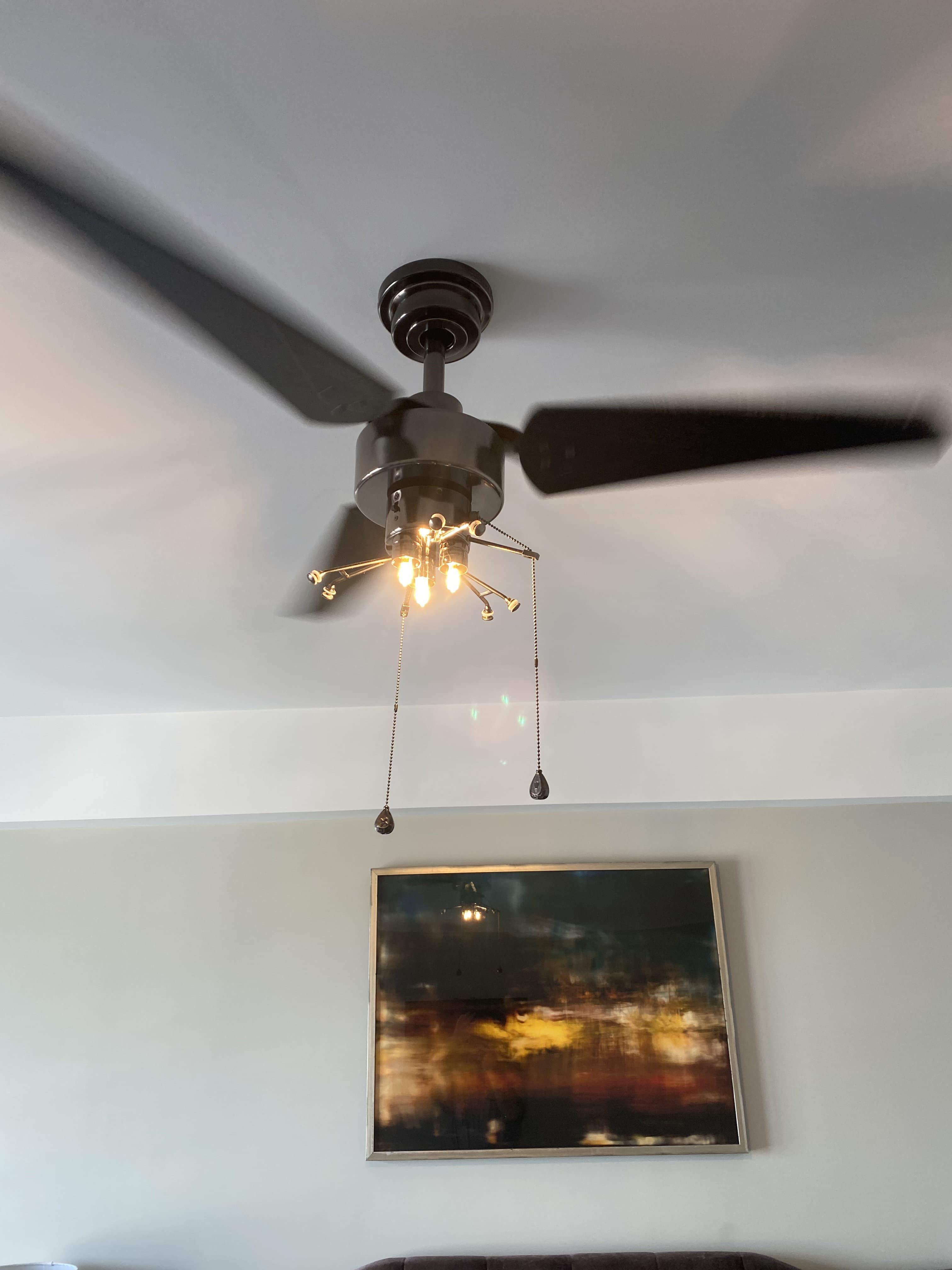 Modern ceiling fan installation with Edison bulbs in renovated room